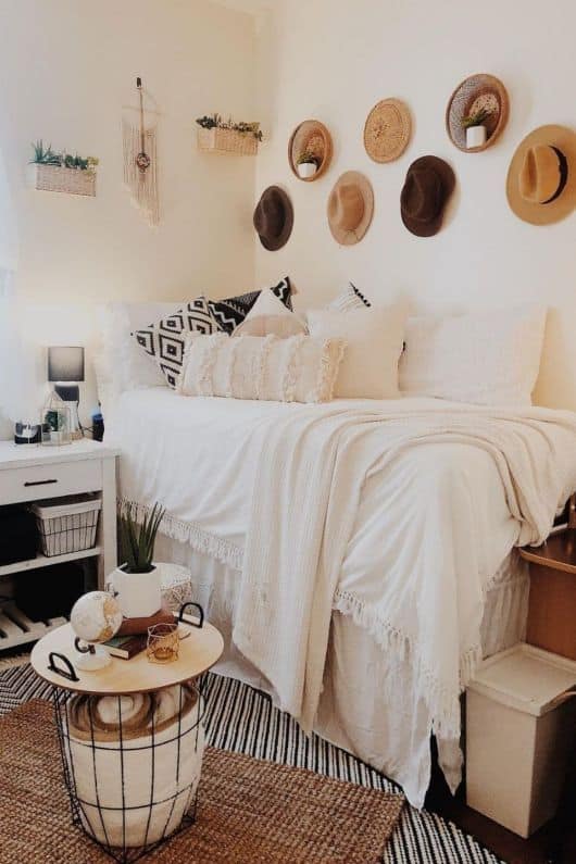 dorm room with hats hung on wall