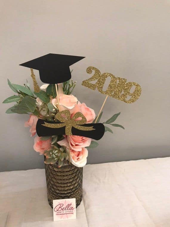 vase with flowers and graduation hat decoration