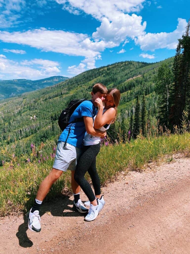 boy and girl hugging on hiking trail