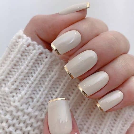 beige and gold fingernail polish