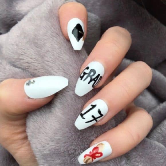 white nails with black graduation cap design