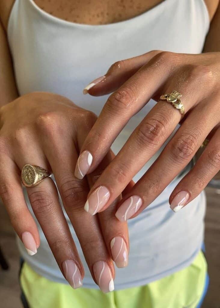 hand with clear and white swirled fingernails