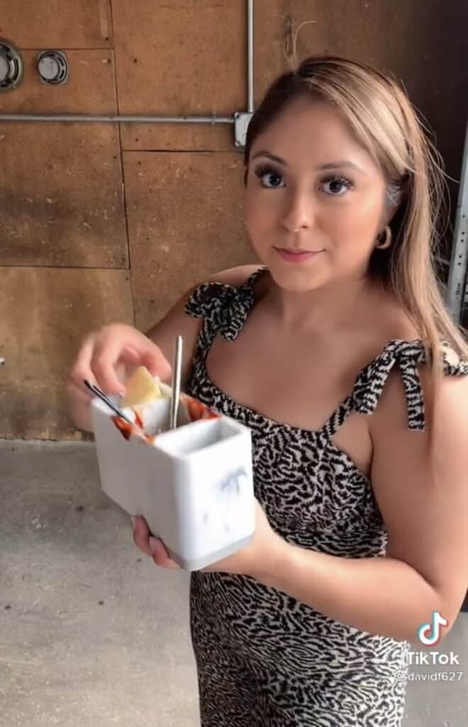 girl holding toothbrush holder