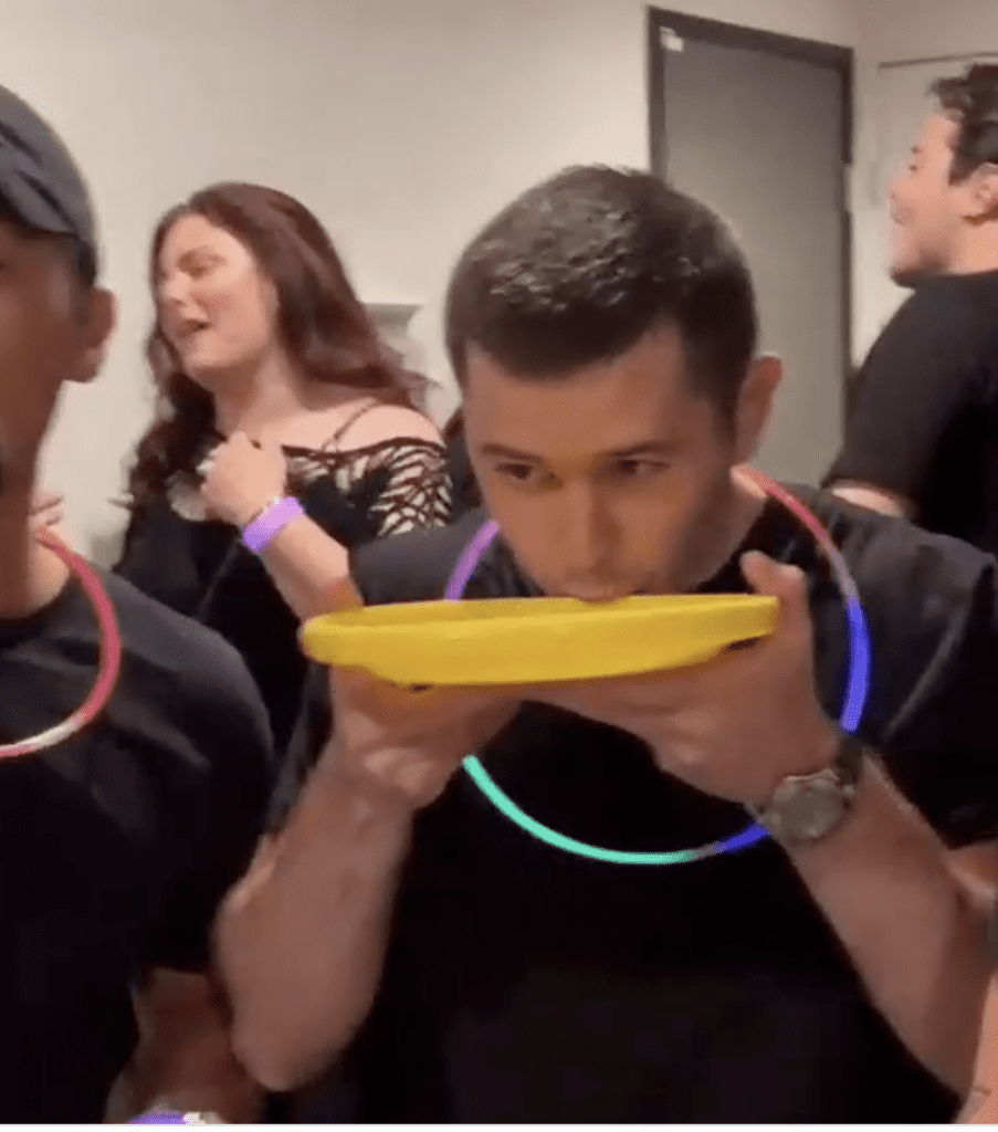 guy drinking out of yellow frisbee at an anything but cups party