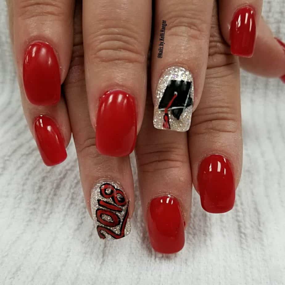 red and gold nail polish with graduation cap design