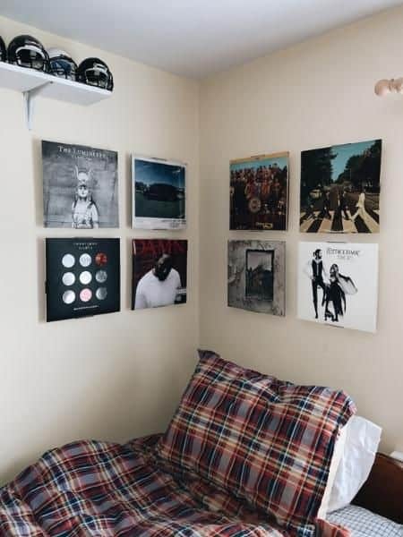 guys dorm room with album cover wall art