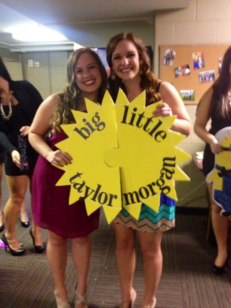 two sorority girls holding matching puzzle pieces