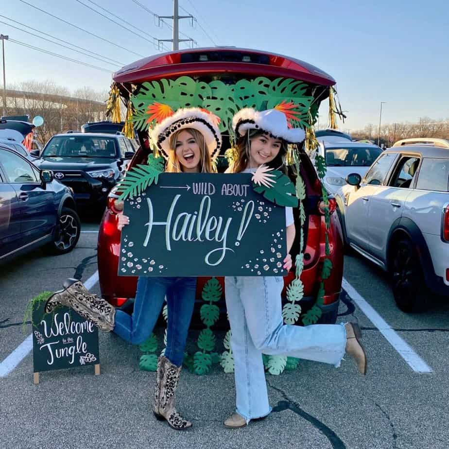 sorority girls standing in front of car