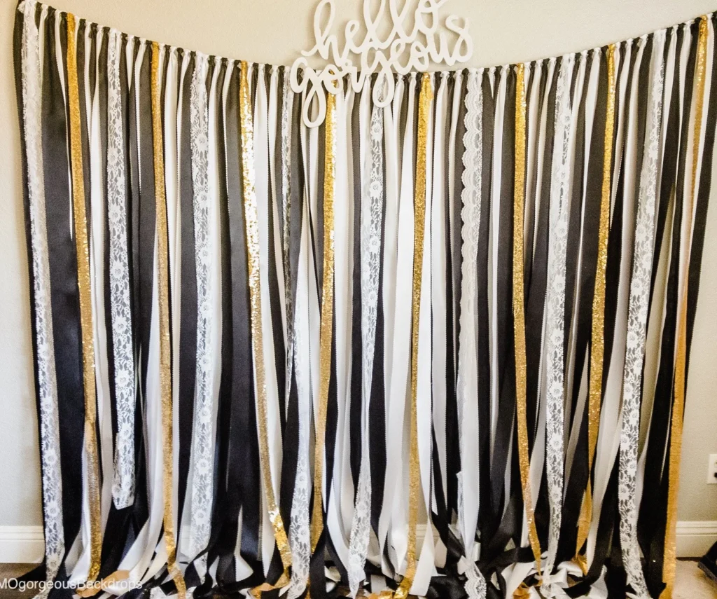 black, white, and gold streamer ribbon photo booth backdrop for graduation party