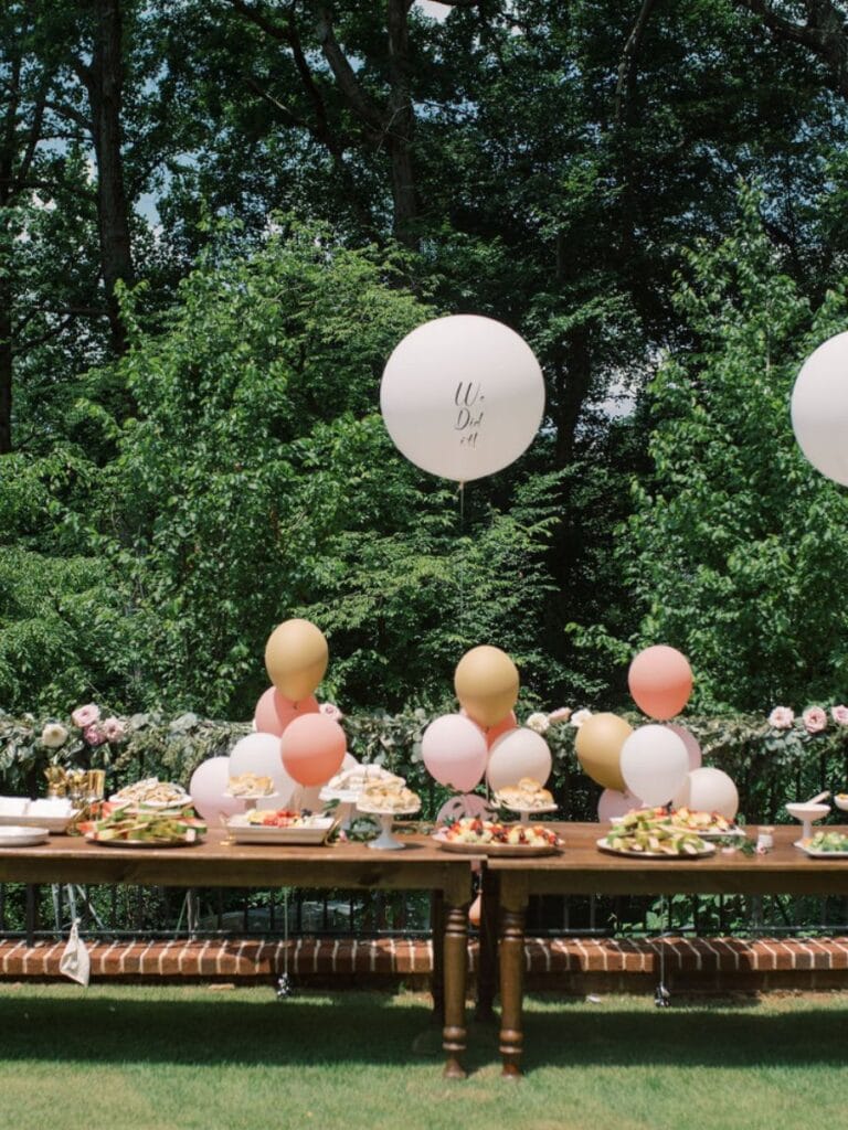 outdoor graduation party with pink and gold balloons