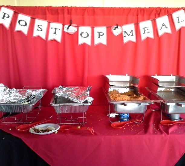 nurse graduation party food served on a red table with a sign that says "post op meal"
